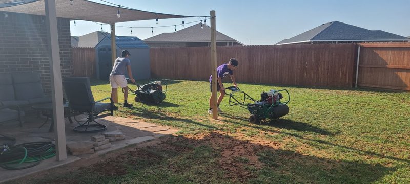 Bold Gold crew core-aerating a Midland lawn