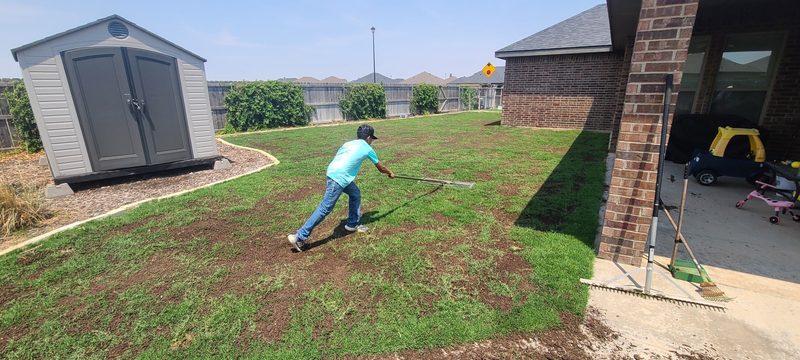 Spreading top dressing across a green lawn