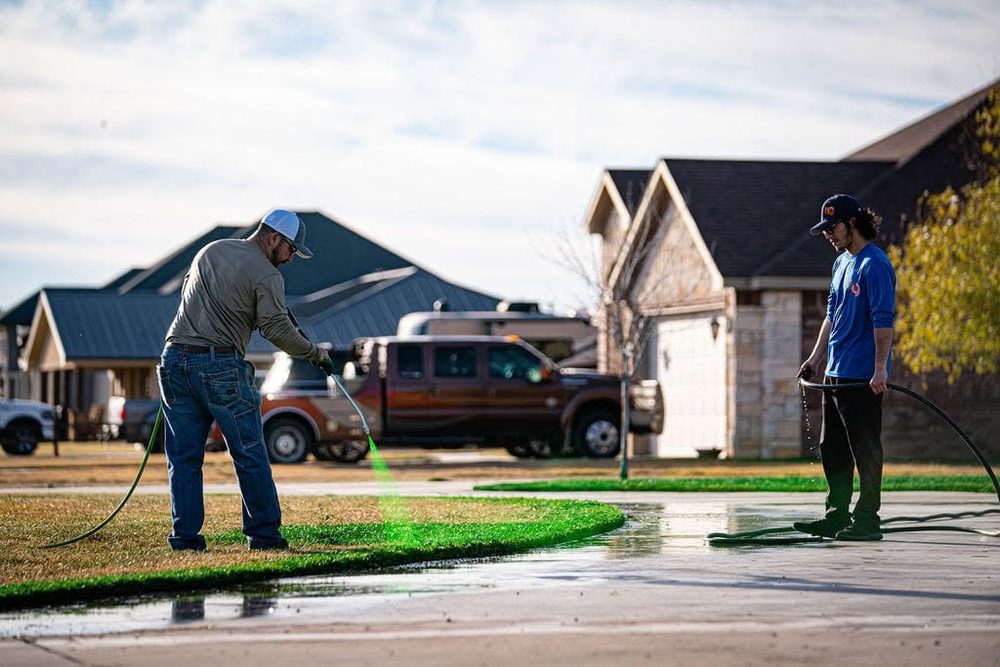 Servicing a lawn in front of a Permian Basin home